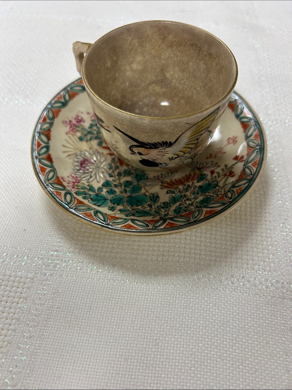 A single vintage Japanese Kutani or lusterware teacup and saucer set